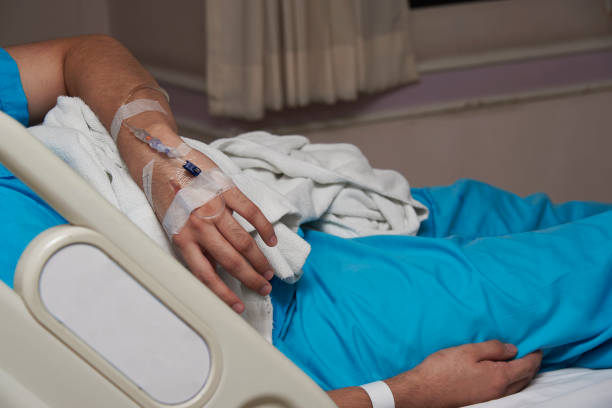 istock patient lying in a bed and iv line on a hand 1013491042