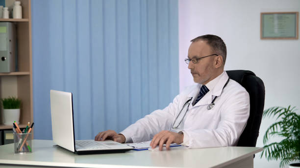 istock Doctor studying treatment methods on laptop, looking for innovative approach 1013497290