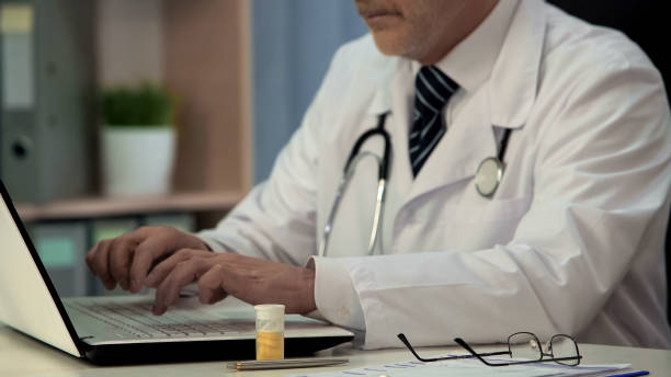 istock Pharmacist typing on laptop research about new drugs, medicine development 1013499454