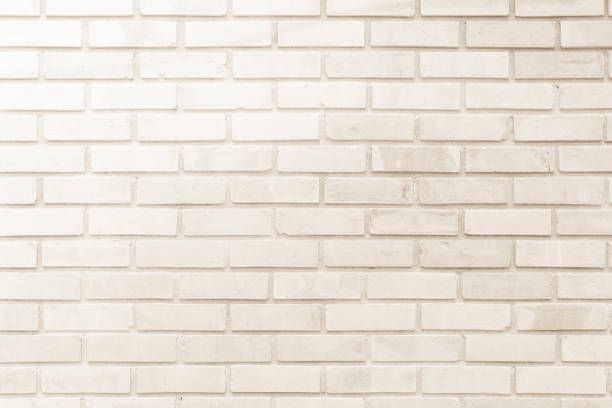 istock Cream and white brick wall texture background. Brickwork or stonework flooring interior rock old pattern clean concrete grid uneven bricks design stack. 1013514736