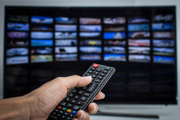 istock Hand pressing remote of smart tv 1013520942