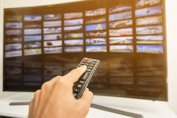 istock Hand pressing remote of smart tv 1013520978