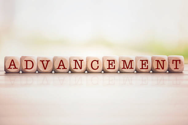 istock Advancement word written on cube wooden blocks. 1013521258