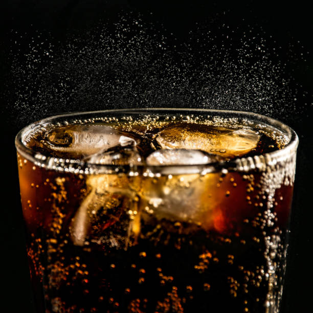 istock poured beverrage into a glass with ice,Cola drink is fizzy 1013530074