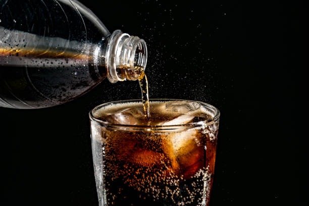 istock poured beverrage into a glass with ice,Cola drink is fizzy 1013530124