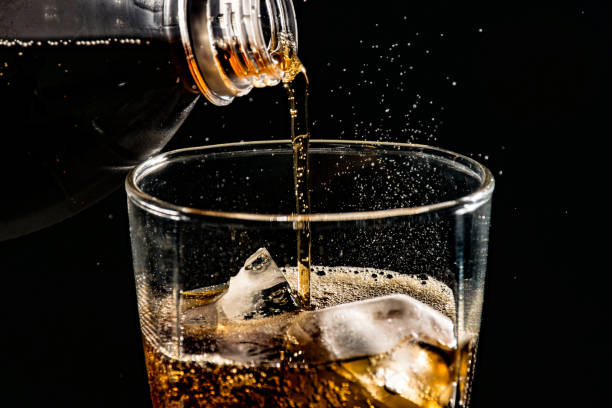 istock poured beverrage into a glass with ice,Cola drink is fizzy 1013530148