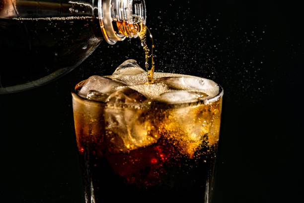 istock poured beverrage into a glass with ice,Cola drink is fizzy 1013530176