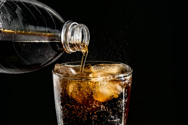 istock poured beverrage into a glass with ice,Cola drink is fizzy 1013530192