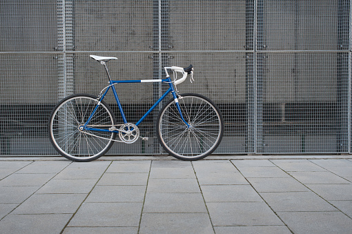 Vintage blue city, road bicycle with white details. Fixie, Hipster culture.