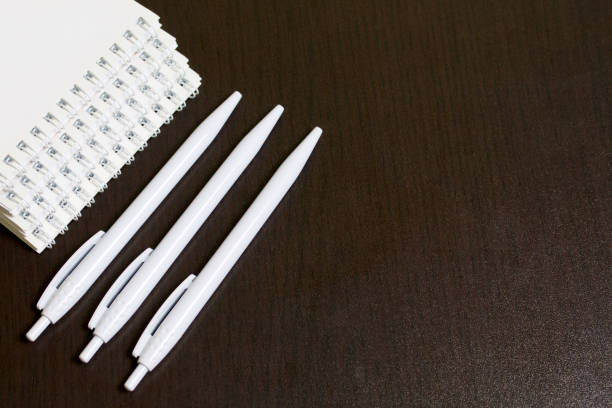 istock White spring pads and ballpoint pens for notes and sketches. 1013542816