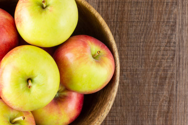 istock Fresh red apple james grieve on brown wood 1013549046