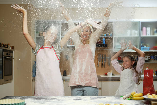 istock A mother with her two kids having fun in the kitchen. 1013558068