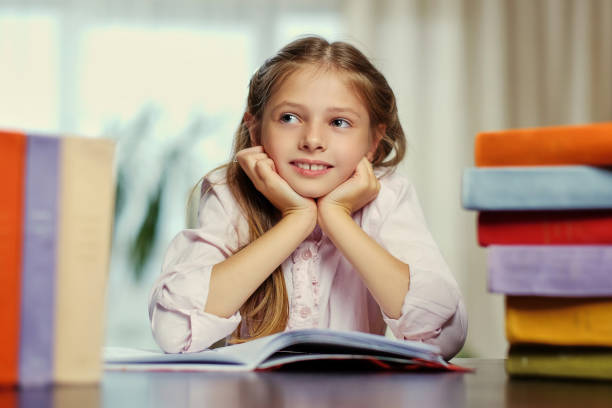 istock Positive little girl likes reading. 1013564026