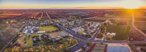 Aerial panorama of Monash - small town in South Australia and farmlands at sunset