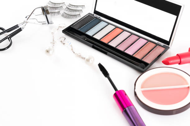Beauty concept : Eye shadow palette , compact blush , lipstick , eyelash curler and false eyelashes  isolated on white background , cosmetic products for makeup