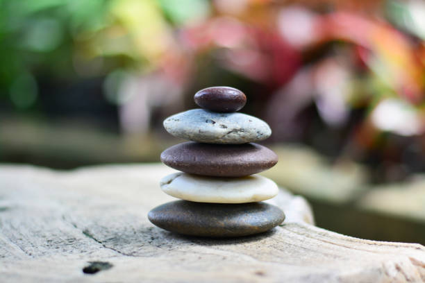 istock Zen stones on gray rock with blossom bokeh background middle position. 1013574096
