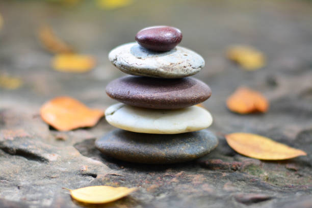 istock Zen stones and fallen leaves on rock middle position. 1013574134