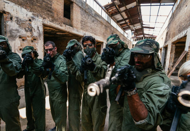 istock Friends playing warfare game with airsoft guns 1013574890