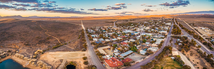 Aerial panorama of rural road passing through Hawker - town in South Australia at sunset