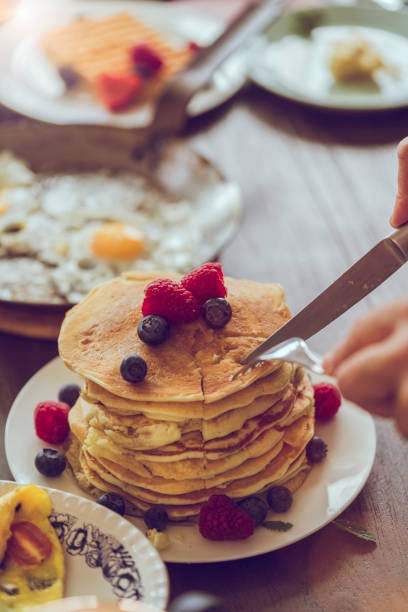 istock Stack of Pancakes with Maple Syrup, Berries and Fresh Coffee 1013582072