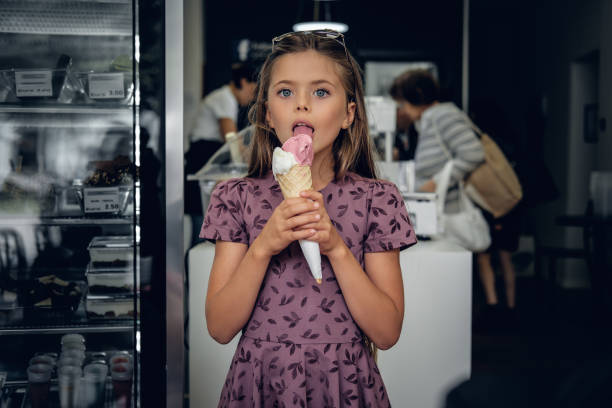 istock A girl eating ice cream in a cafe. 1013587494