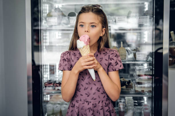 istock A girl eating ice cream in a cafe. 1013587730