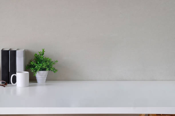 istock Minimal desk with books, coffee mug, workspace and copy space. 1013597050
