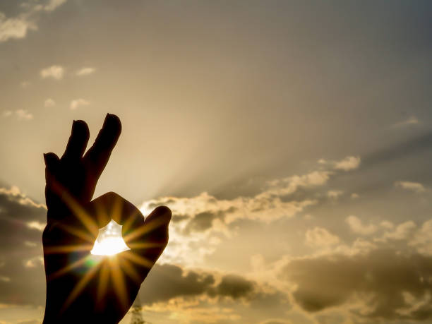 istock round hand sign Ok with sunny background 1013602176