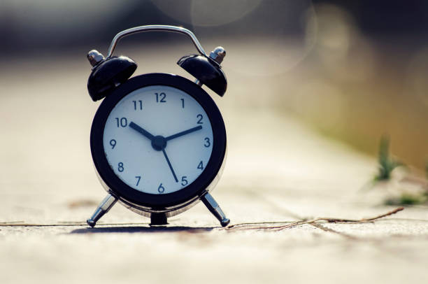 istock Vintage alarm clock on yellow background with bokeh 1013602246