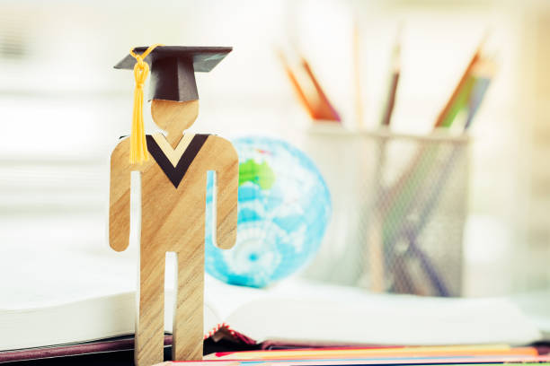 istock Australia Education knowledge learning study abroad international Ideas. People Sign wood with Graduation celebrating cap on open textbook with model global map, alternative studying world wide 1013617078