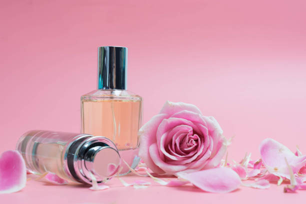 istock Beautiful perfume bottles  and rose on pink background 1013621218