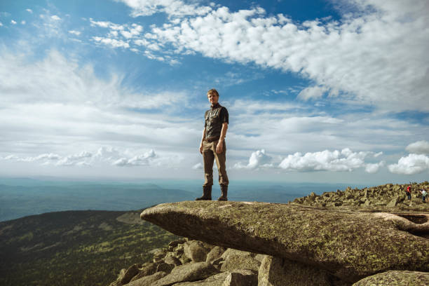 istock a man stands in the mountains 1013622026