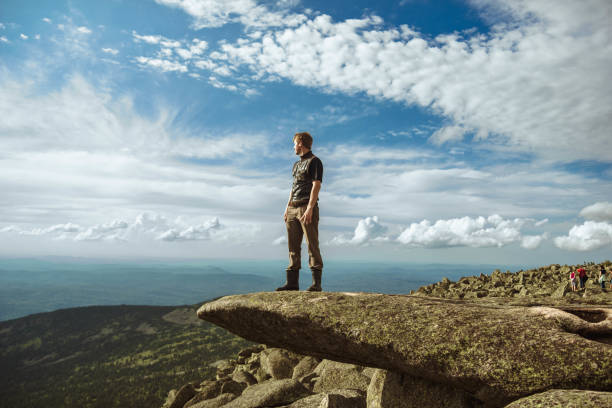 istock a man stands in the mountains 1013622056