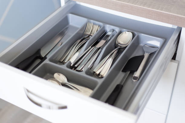 close up of drawer with cutlery in kitchen stock photo