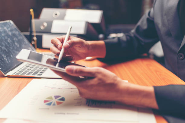 istock business documents on office table with smart phone and digital tablet and graph financial with social network diagram and man working in the background 1013625358