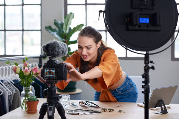 istock Young female vlogger adjusting her video equipment to record content 1013632298