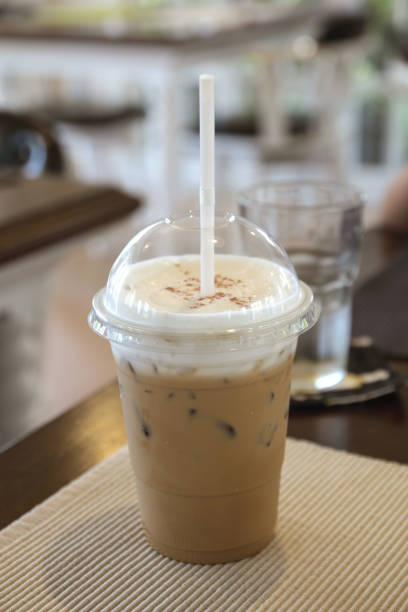 istock ice coffee in a plastic glass on the table. 1013639620