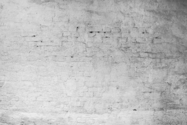 istock grunge cracked white brick wall covered plaster 1013640278