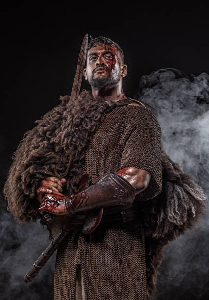 istock Weapon wielding Indian Descent warrior barbarian king alone in studio shoot 1013648062