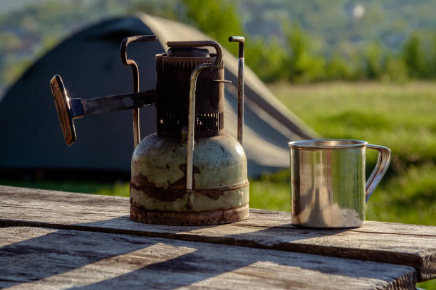 istock An old Soviet kerosene primus  and a steel mug on nature. 1013648814