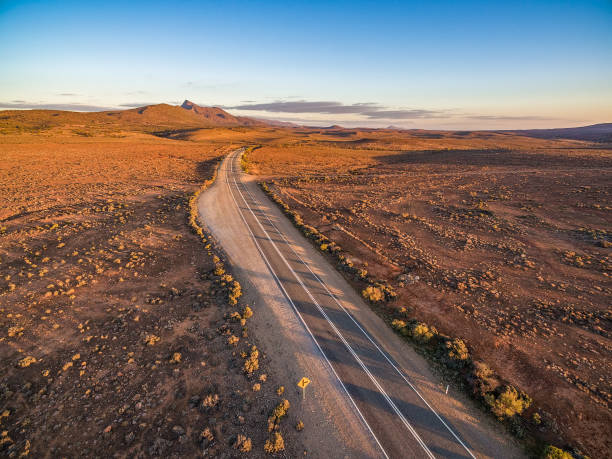 istock Beautiful sunset over rural highway passing through South Australian desert 1013648976