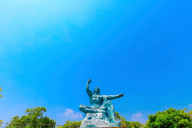 Statue of Saint Joseph holding Jesus over a blue sky.