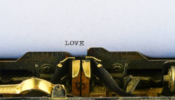 istock Closeup on vintage typewriter. Front focus on letters making LOVE text. Romantic concept image with retro office tool 1013652750