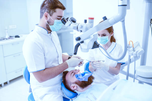 istock Team Of Dentists Operating On Patient 1013655320