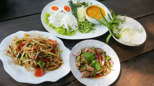 istock thai food and vegetables on table wood backgrounds 1013658368
