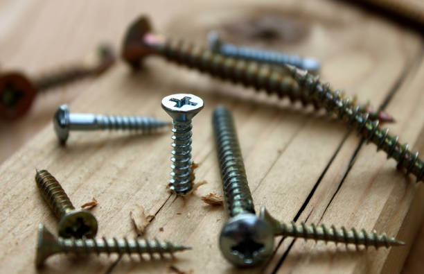 istock screws in a wooden board 1013661258