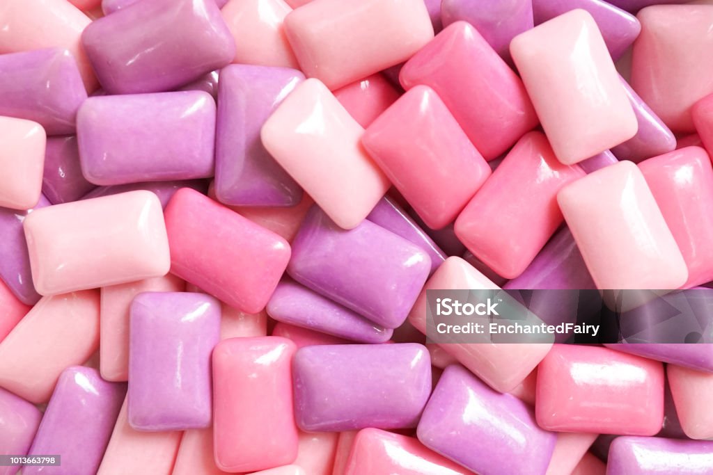 Gum. A various shades of pink and purple gum for food pattern and background. gum. colorful confectionary background of candy gums in different shades of pink and purple. Bubble Gum Stock Photo