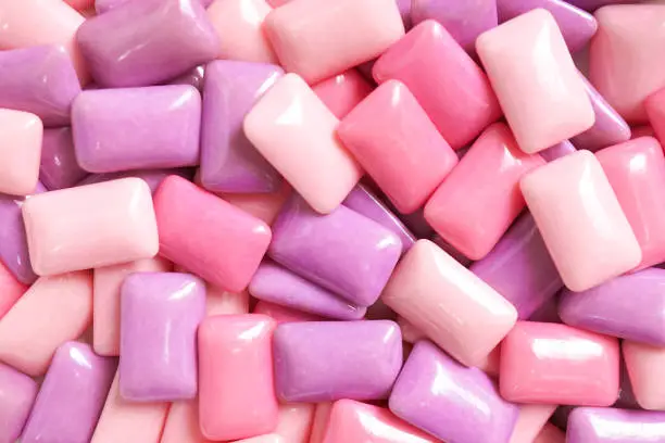 Photo of Gum. A various shades of pink and purple gum for food pattern and background.