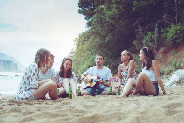 istock Friends enjoying on the beach 1013672206