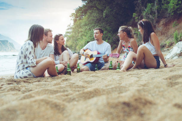 istock Friends enjoying on the beach 1013674880